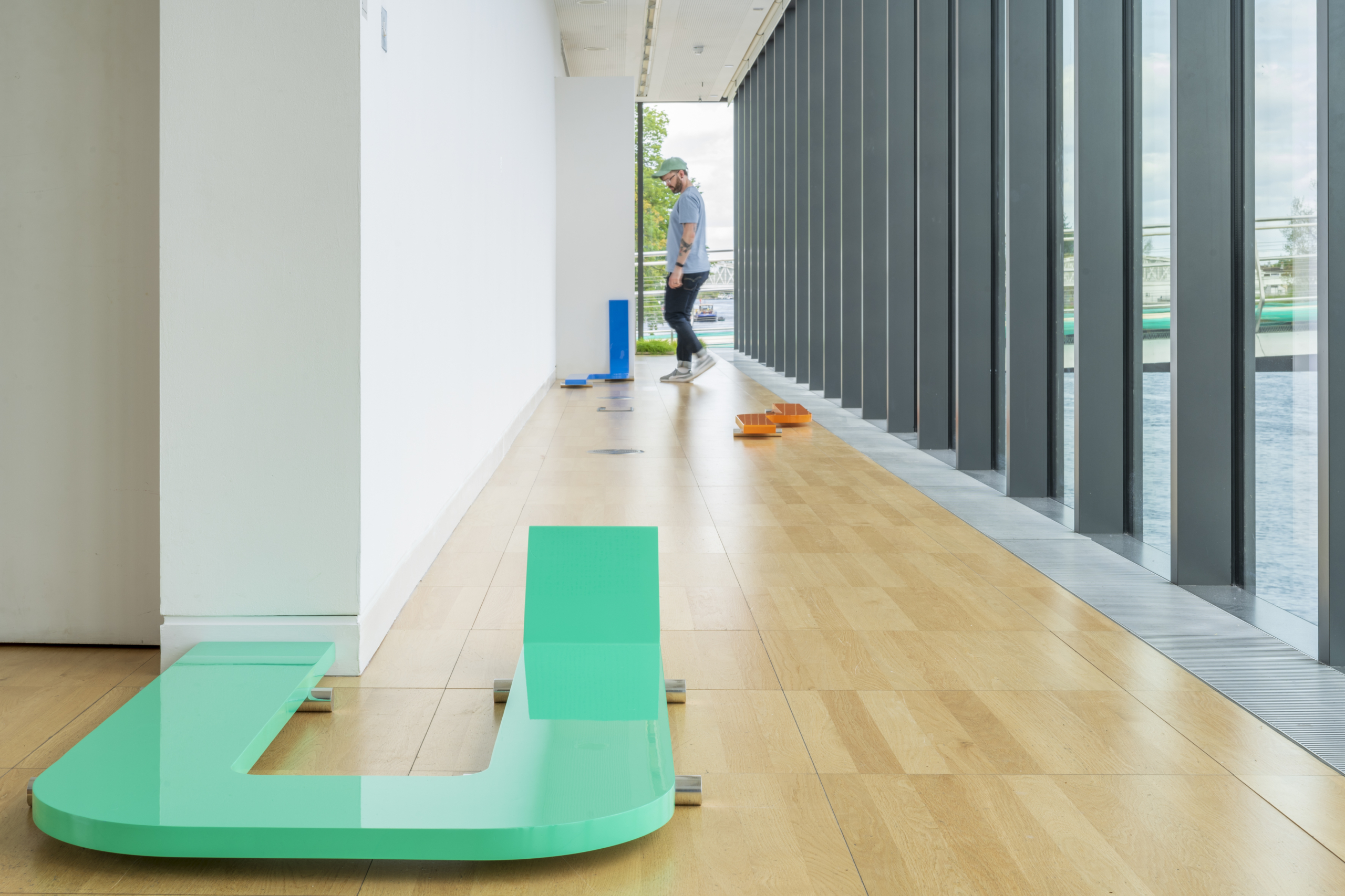 Colourful installation on the floor in a hallway at exhibition Portals at Luan Gallery