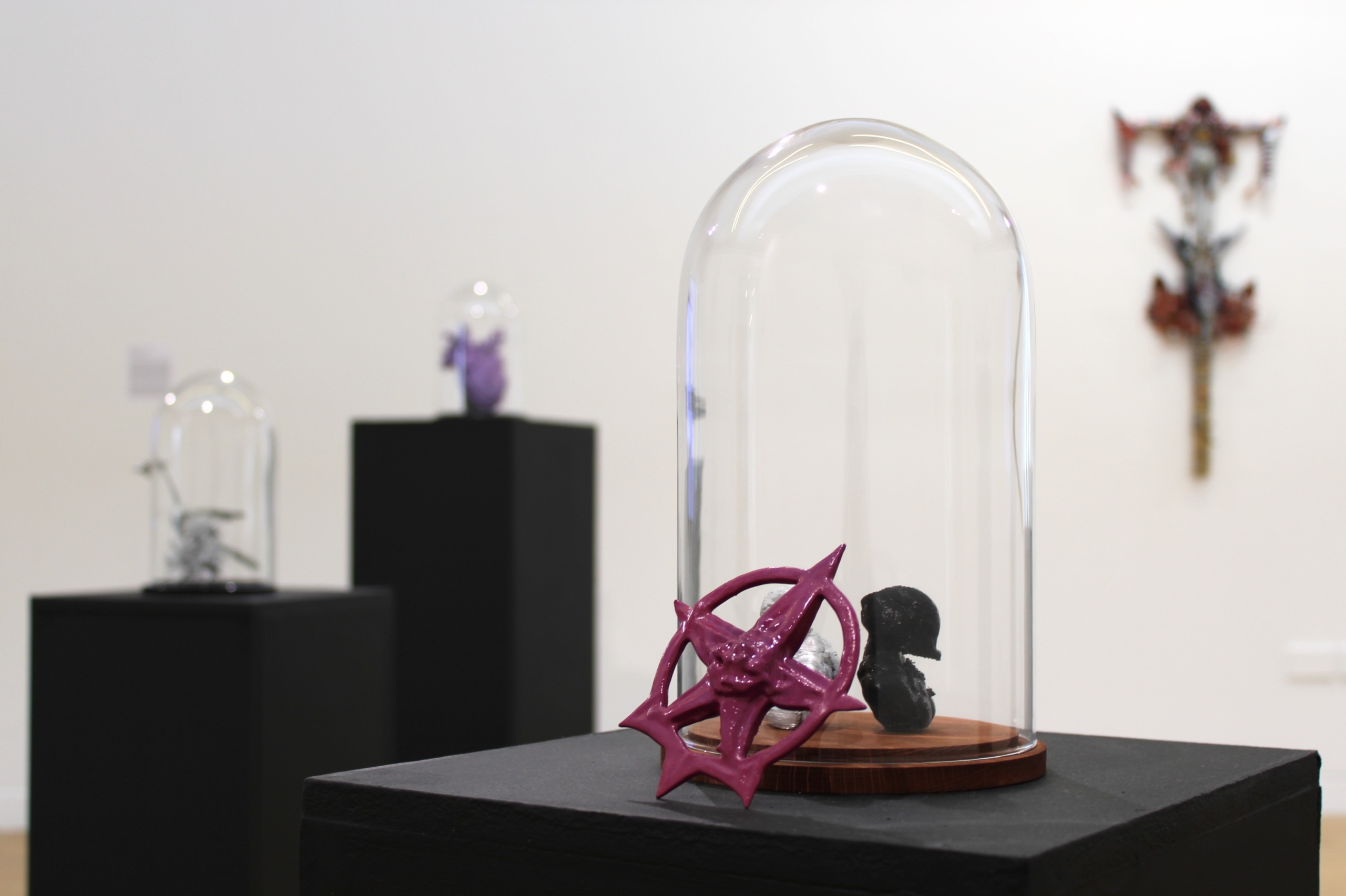 Art in a glass bell on the floor at the exhibition System Arming at Luan Gallery