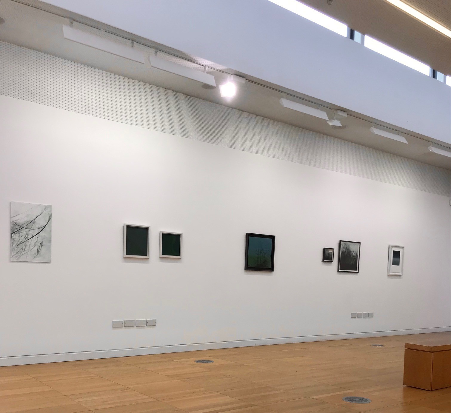 Hilary Kinahan exhibition at Luan Gallery - 7 art pieces on a white wall and a wooden floor