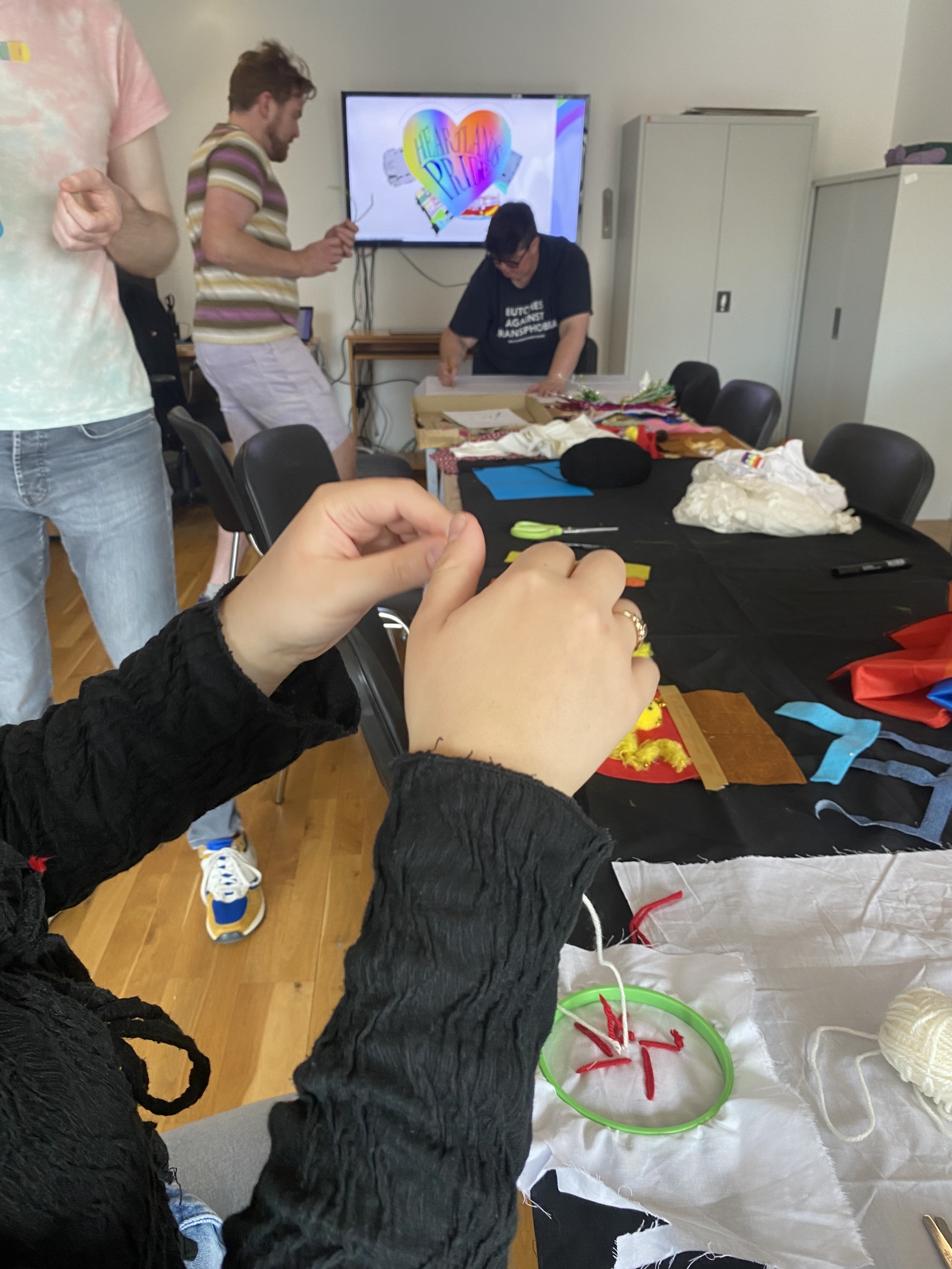 Banner-making workshop at Luan Gallery photo with hands and people in background