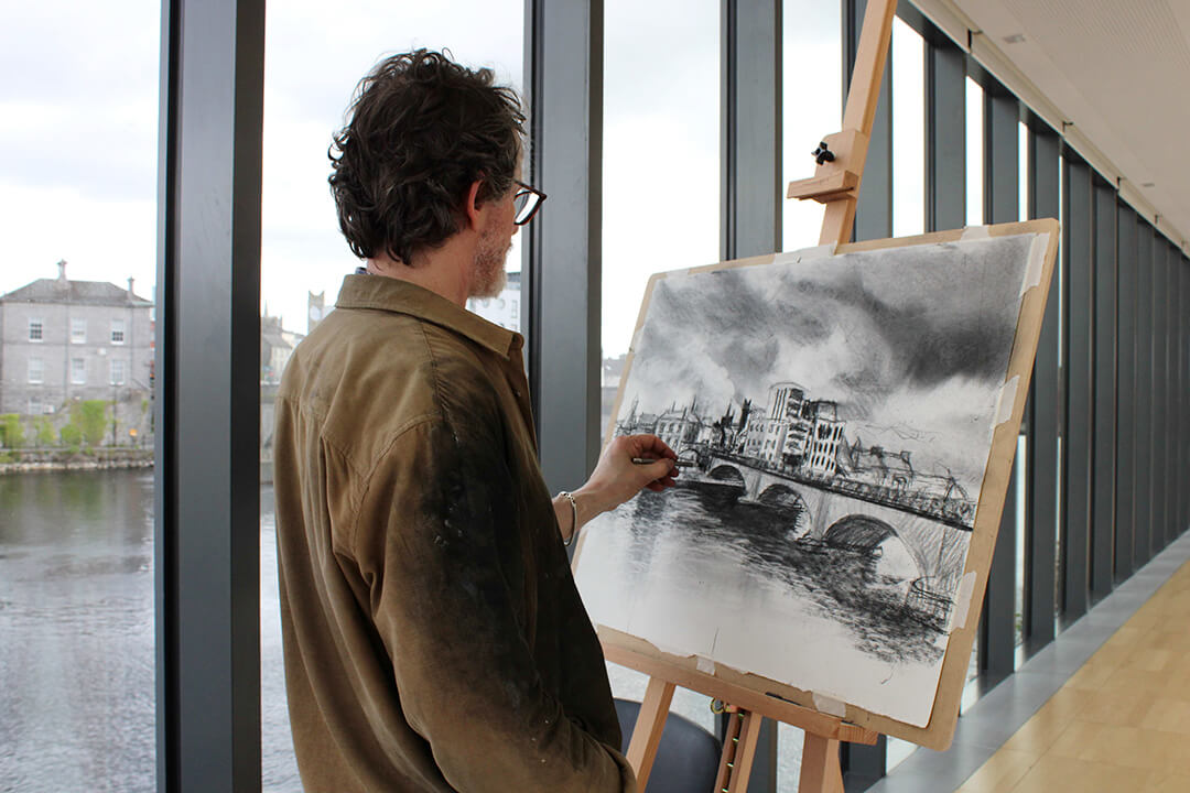 Artist Michael Wann doing a landscape drawing on an easel the river gallery space at Luan Gallery Workshop on National Drawing Day 2026